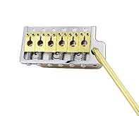 1 PRS gold guitar tremolo system bridge.