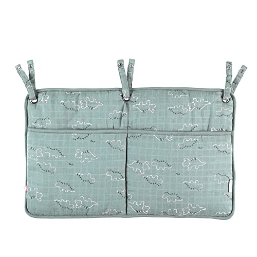 Poche de rangement verte dinosaure pour une table à langer ordonnée