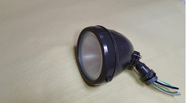Flood light resting on a surface, showing its compact design