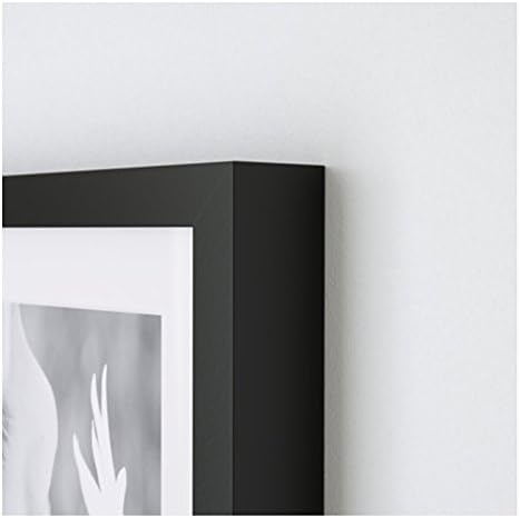 Close-up of the black IKEA Ribba picture frame corner on a white wall.