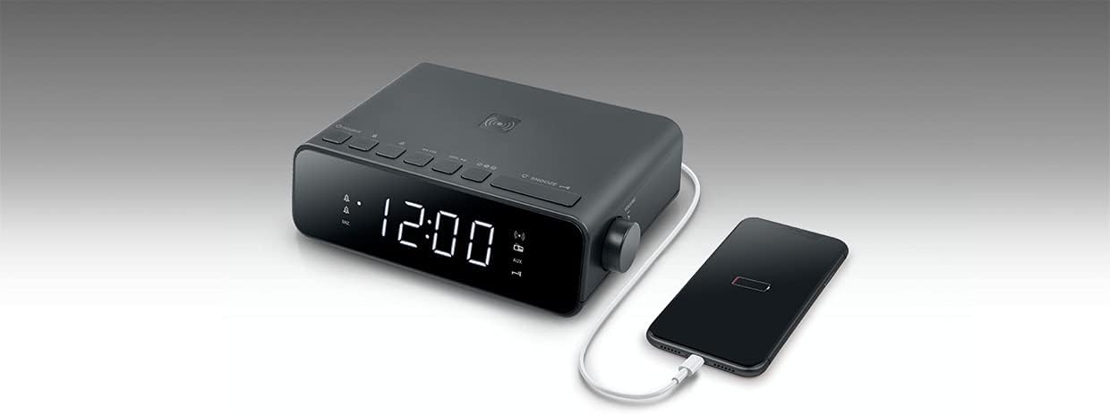 MUSE M-175 WI Radio Alarm Clock with smartphone on wireless charging pad