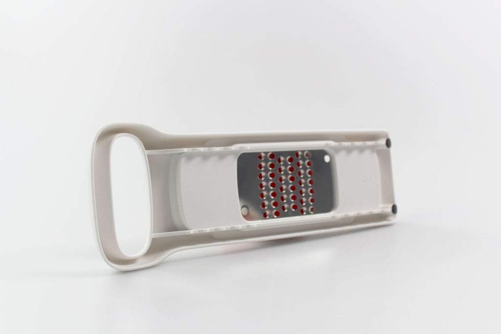 Tupperware SpeedyMando Grater, underside view showing the grating surface
