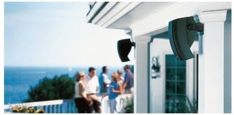 Bose 251 Outdoor Environmental Speakers mounted on a house, with people enjoying an outdoor space in the background.