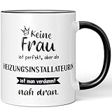 JUNIWORDS Tasse, Keine Frau ist perfekt, aber als Heizungsinstallateurin ist man verdammt nah dran, Schwarz (6352771)