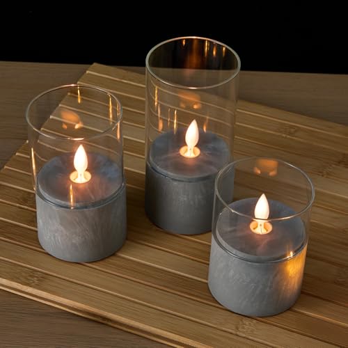 Image of amazon basics LED Pillar Candles, Set of 3 (7.5X10 CM, 7.5X12.5 CM, 7.5X15 CM), Clear Glass & Cement Base, Warm White Flickering Flame, Remote Controlled, Flameless Battery Operated Pillars