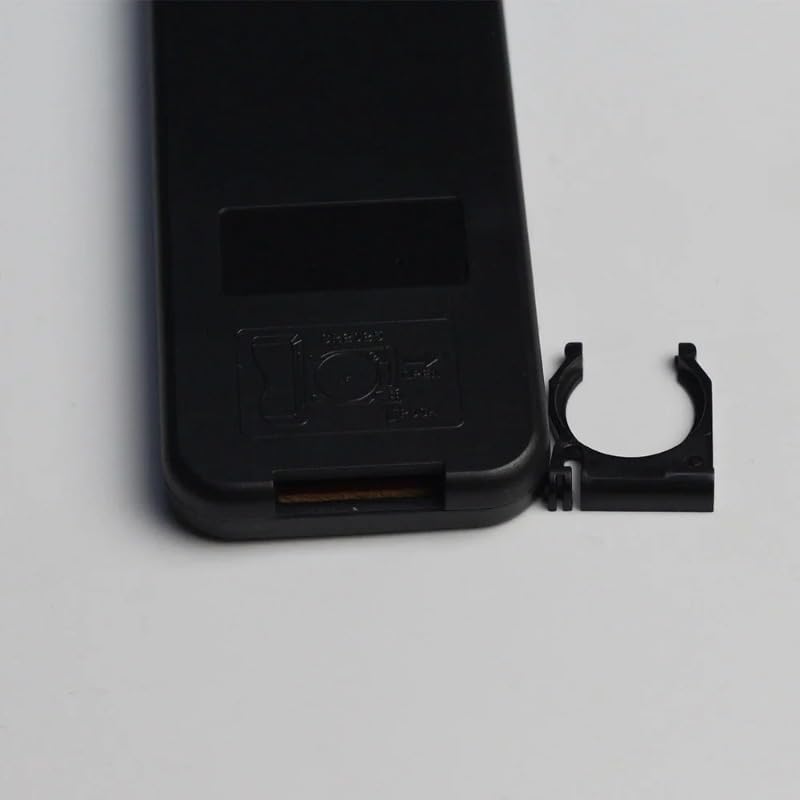 Back of the remote control with the battery cover removed, showing the battery clip