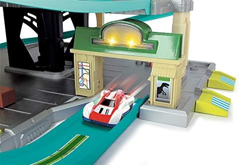 A die-cast car passing through a gate with activated lights, indicating the location of light and sound features.