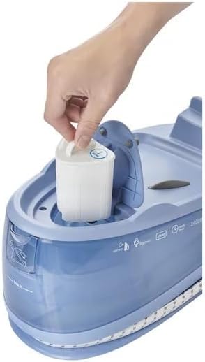 Hand inserting the anti-limescale filter into the steam iron station