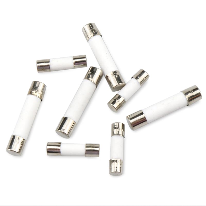 A collection of various ceramic tube fuses, showing different sizes and amperages.