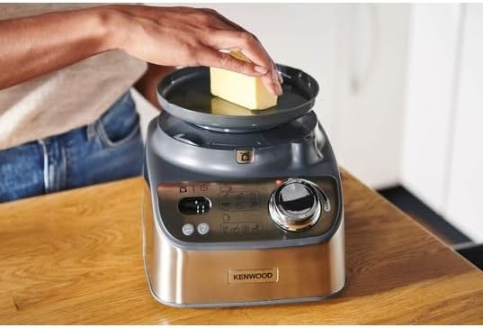 Person placing butter on the Kenwood MultiPro XL Weigh+ Food Processor's weighing tray