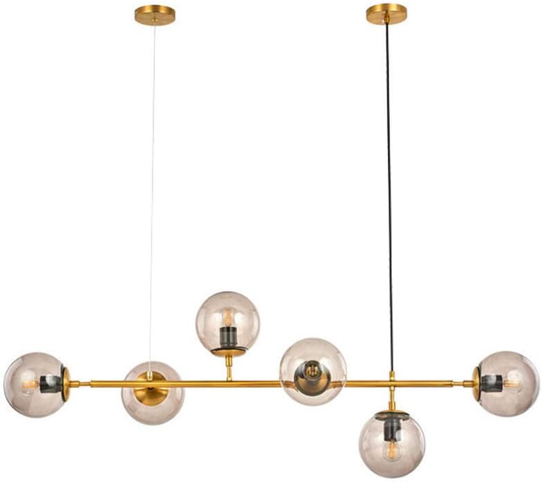 Lampada a sospensione a 6 luci con raccordi in ottone e paralume a Globo in vetro trasparente, ideale per isola cucina e sala da pranzo.