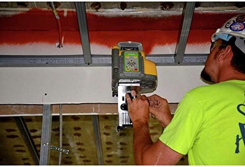 A construction worker adjusting the SPECTRA PRECISION HV302G-1 Green Beam Rotary Laser, which is mounted on a bracket attached to a ceiling grid, projecting a green laser line.
