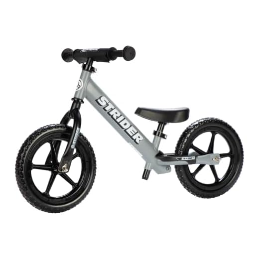 Strider 12” Sport Bike, Matte Gray - No Pedal Balance Bicycle for Kids 1 to 4 Years - Includes Safety Pad, Padded Seat, Mini Grips & Flat-Free Tires - Tool-Free Assembly & Adjustments