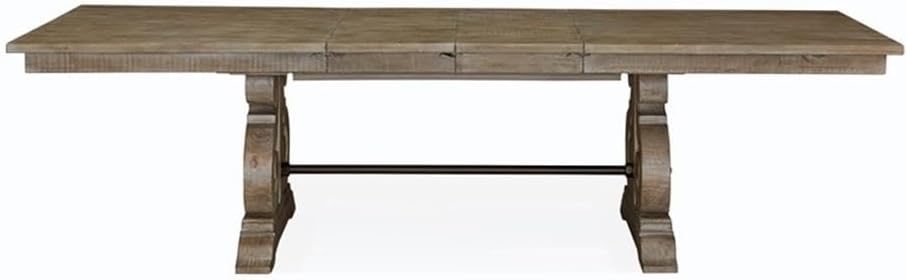 Front view of the Magnussen Tinley Park Rectangular Dining Table, highlighting the two ornate pedestal bases and the connecting metal stretcher bar.