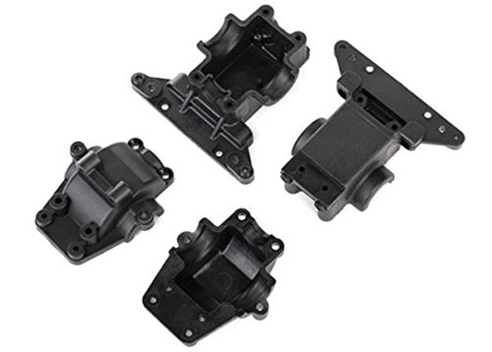 Four black plastic Traxxas bulkheads and differential housings