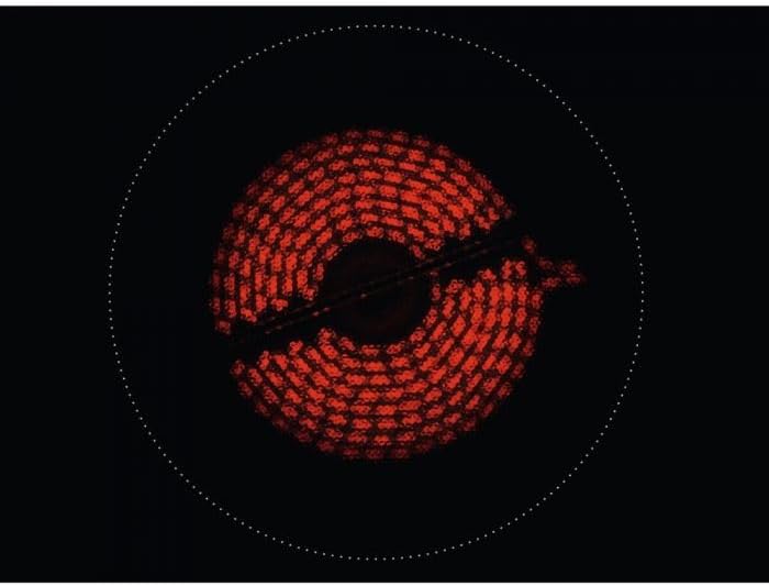 A radiant ceramic cooking zone with an inner and outer ring glowing red, indicating a dual or extended zone is active.