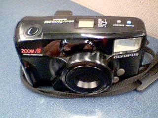 Olympus Infinity Zoom 210 camera with strap attached