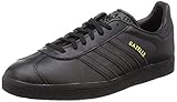 adidas Gazelle Sneaker, Zapatillas de Deporte Unisex adulto, Core Black Gold Metallic, 46 2/3 EU