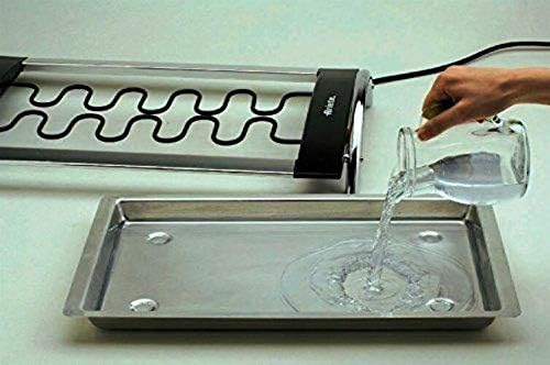 Adding water to the drip tray of the Ariete Churrasco 732 Electric Grill
