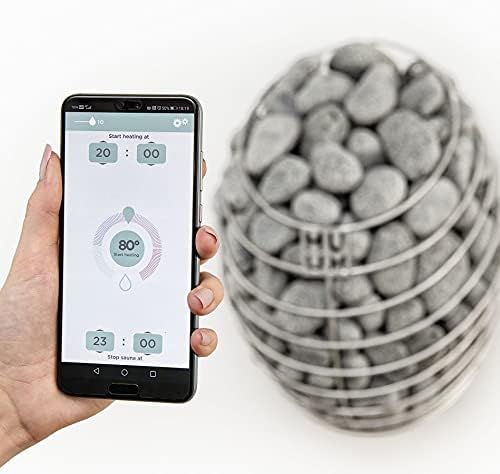 Smartphone displaying HUUM app with sauna heater in background