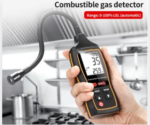 Hand holding the SW-733A gas detector in a kitchen setting near a stove
