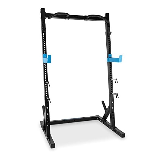 CAPITAL SPORTS Racktor - Jaula musculacion, Power Rack con 35 Alturas, Dominadas Torre con 2 Ganchos en J, Brazos de Seguridad, Barra dominadas, 4 Soportes para Discos de hasta 31mm, Negro