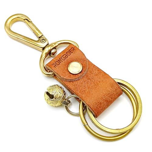 a brown leather key fob with a brass key ring and a small bell hanging from it