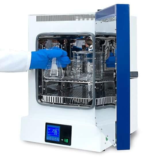 User placing a flask into the oven chamber