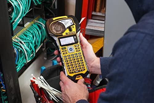 A person using the Brady M210 label printer to create labels for wires in an electrical panel.