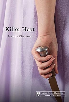 Killer Heat cover with a closeup up a lady's hand holding a knife 