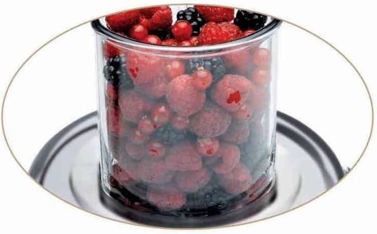 Mixed berries in the juicer's feed chute