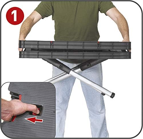 A person's hand pressing a red release button on the side of the folded work table, initiating the unfolding process.