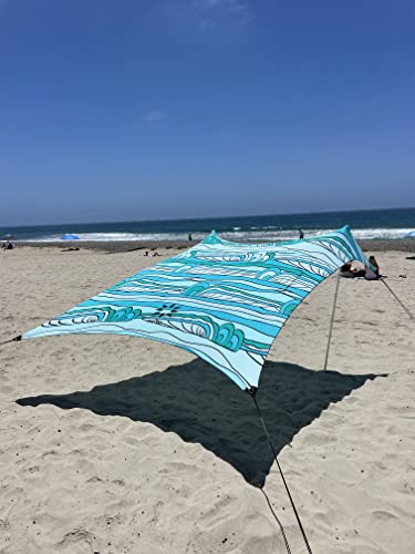 Image of Neso Portable Beach Tent Sun Shelter with Sand Anchor - Lightweight Beach Shade Canopy - Easy Setup for Family Outings - Patented Reinforced Corners - UPF 50+ Sun Protection - 7 x 7ft - Swells
