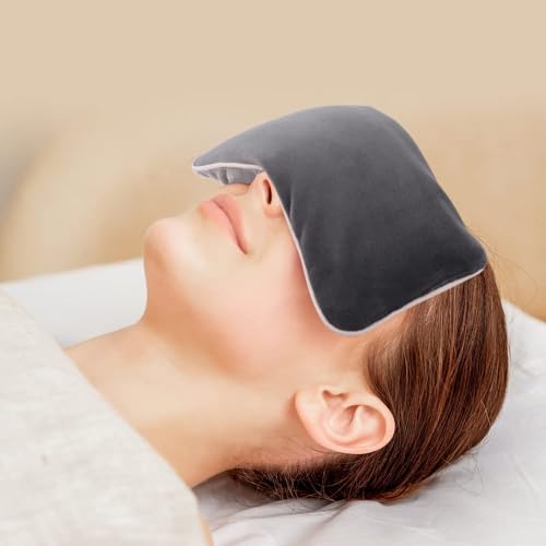 Woman resting with a dark weighted eye pillow across her eyes