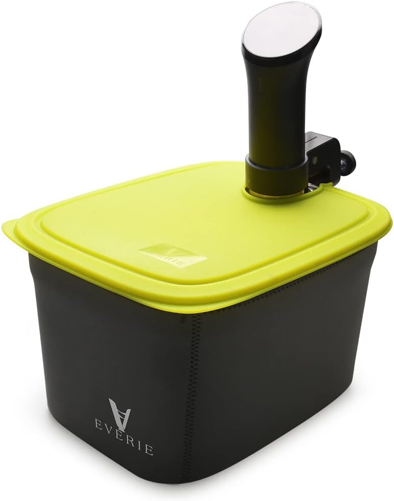 The green silicone lid partially open, revealing the hinged design, with a sous vide cooker still inserted.