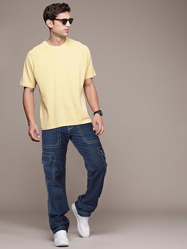 Image of RIG BONE Men's Relaxed Fit Cargo Jeans with Functional Pockets Comfortable High Rise Design Durable Denim Mid Wash Ideal for Casual Wear Travel Outdoor and Urban Adventures