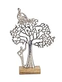 Statuette représentant des personnages stylisés autour d'un arbre de vie en métal sur socle, hauteur 44 cm.