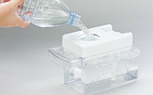 A hand pouring water from a bottle into the refrigerator's water tank for the dispenser and ice maker.