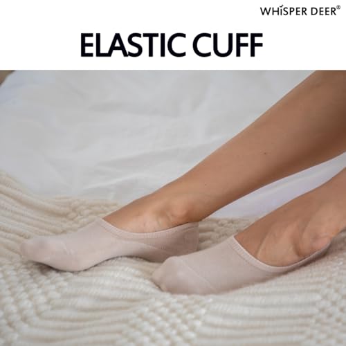 A pair of Whisper Deer No Show Liner Socks in beige worn on feet, highlighting the elastic cuff design, with the brand name and "ELASTIC CUFF" text overlay on a textured background.