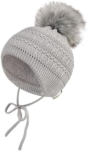 Sterntaler Strickmütze mit Kunstpelz-Pompon, angeschnittenen Ohrenklappen und Bindebändern – Mädchen – warme Mütze für Baby und Kinder, Mittelgrau, Größe 49
