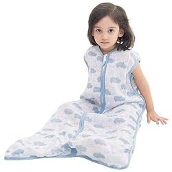 toddler girl in sleep sack in an article on baby climbing out of crib