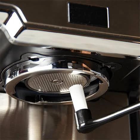Budan Cleaning Brush being used to clean an espresso machine group head