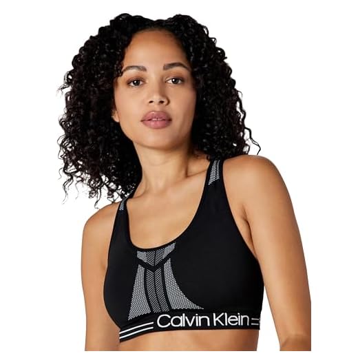 Calvin Klein Women's Performance Moisture Wicking Medium Impact Reversible Seamless Sports Bra, Black/White, Large
