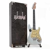 Size: 10in/25cm Approx. Height, Body & Neck: Wood, Details/Finish: Plastic and Metal, Display Stand Included (For Display Purposes Only, Cannot be Played) T. REX GLAM ROCK LEGACY: Embodying the unmistakable sound of T. Rex's glam rock revolution, thi...
