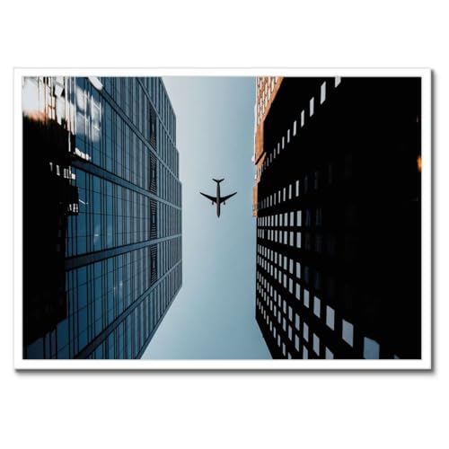 Poster deco 70x50 cm avion entre les batiments avec cadre noir mural