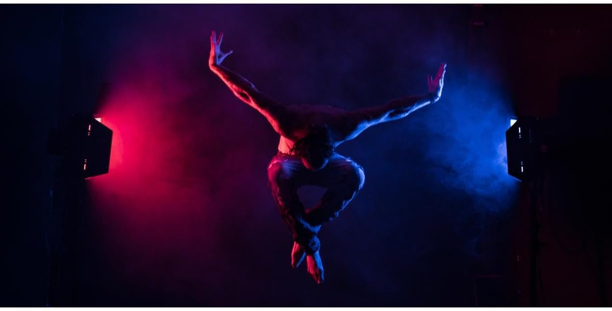 A dancer illuminated by dynamic red and blue lighting from the Rotolight Titan X1
