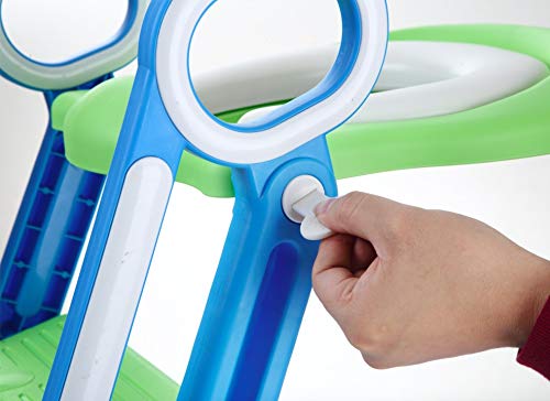 A hand using a white plastic screwdriver to tighten a white plastic screw on a blue and green potty training toilet seat handle.