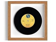 This is the genuine 7" record, raised within the frame, giving a fantastic 3D 'floating' effect. This is surrounded by either plain white cartridge paper or vintage sheet music and a black, white or oak-effect frame, with a clear plastic glass front....