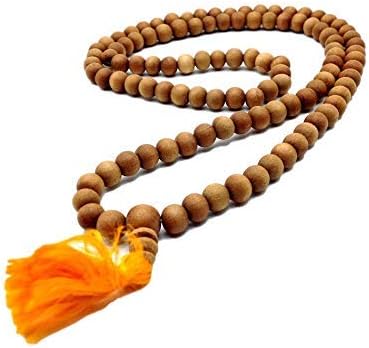 Mala prayer necklace made of round light brown wooden beads, looped in a long strand with a bright orange fabric tassel pendant at the bottom, shown on a white background.