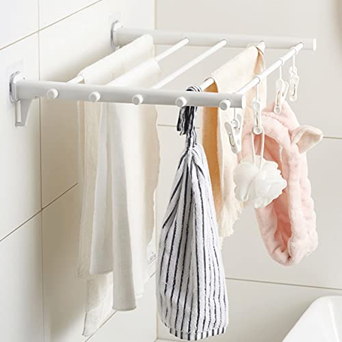 Étendoir vêtements pliable pour étendre sa lessive sur un cintre mural compact